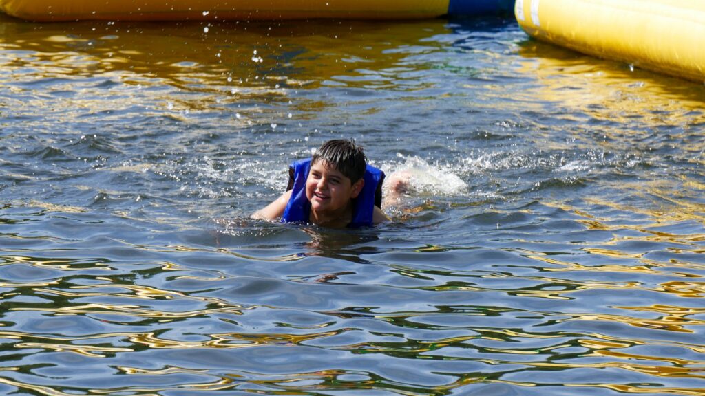 Boy swimming in lake (Courtesy of YMCA Camp Tumbleson Lake)